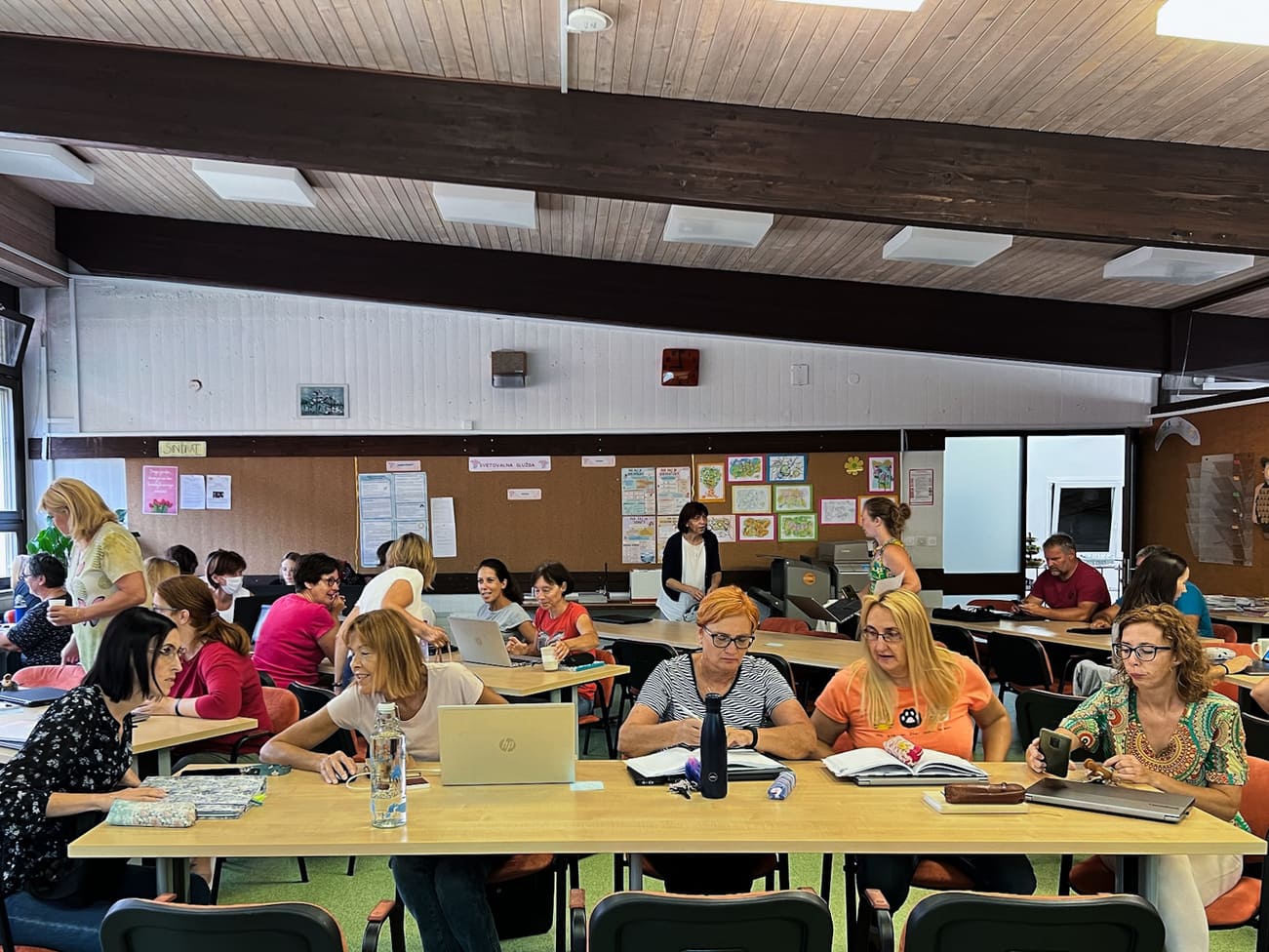 Groups of teachers collaborating on various team-based tasks during a training conducted by an Erasmus+ invited expert on digital tools in the classroom