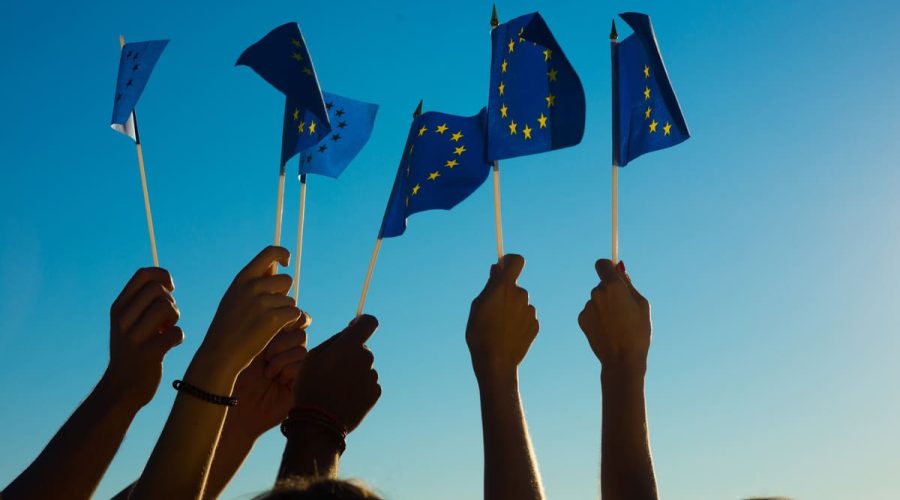 Hands holding european union flags for erasmus programme 2028 2034