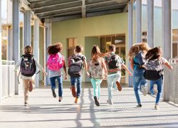 Students shown running with school bags on their back in the school hallway, a representation of school management course for principals and school leading staff course at Platform21