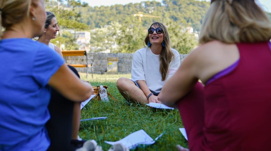 Teachers sitting on the grass during an outdoor mindfulness and well-being session in Split